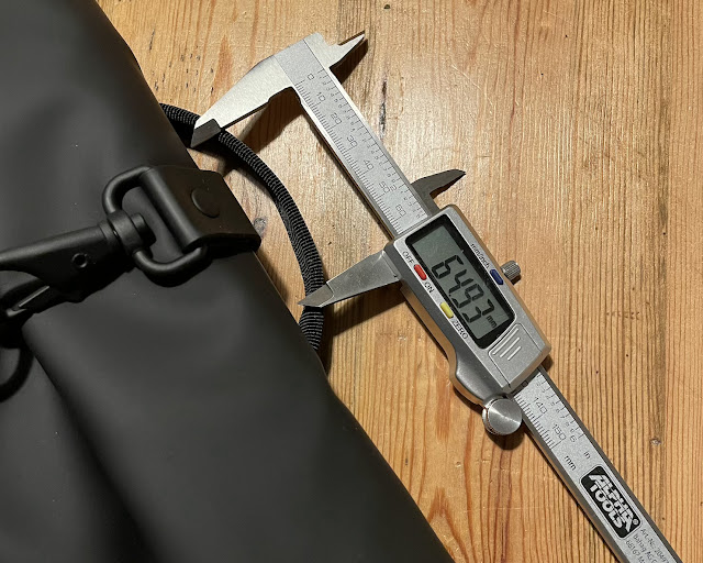 A backpack handle being measured by a digital caliper